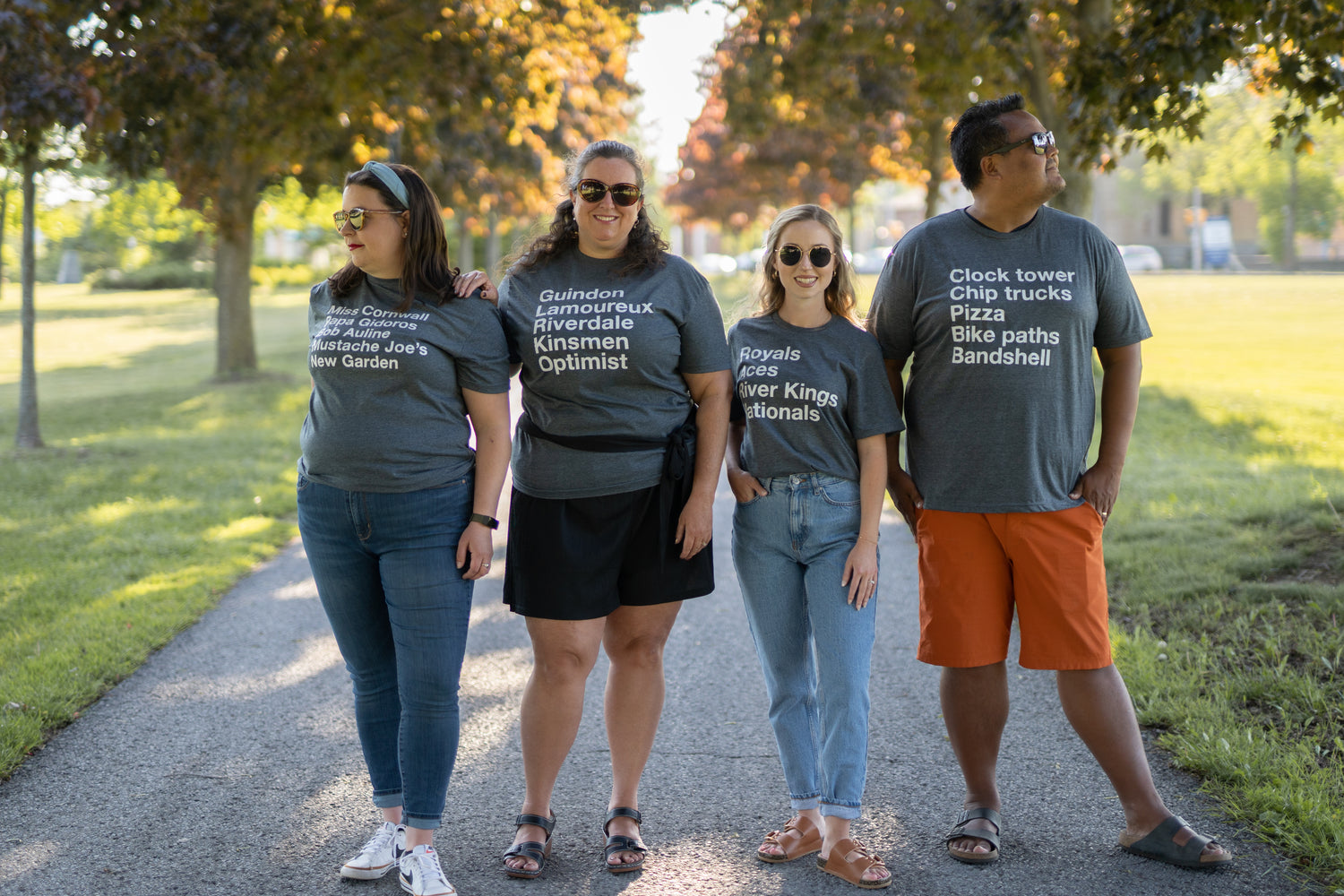 3 females and a male posing in a line wearing grey t-shirts from the Cornwall hometown collection