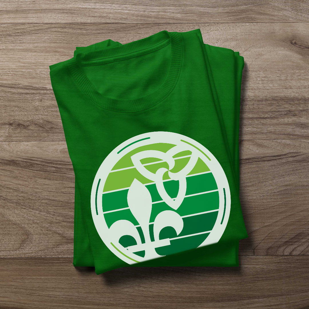 Folded Retro-Inspired Franco-Ontarien Shirt on a wooden background, featuring a design with the trillium and fleur-de-lys.