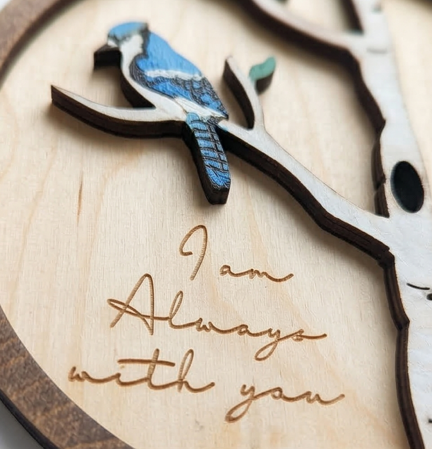 Wooden art with blue jay bird and branch, featuring the engraving 'I am Always with you'.