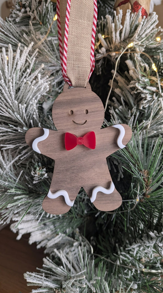 Layered walnut and acrylic gingerbread boy ornament with red bow tie