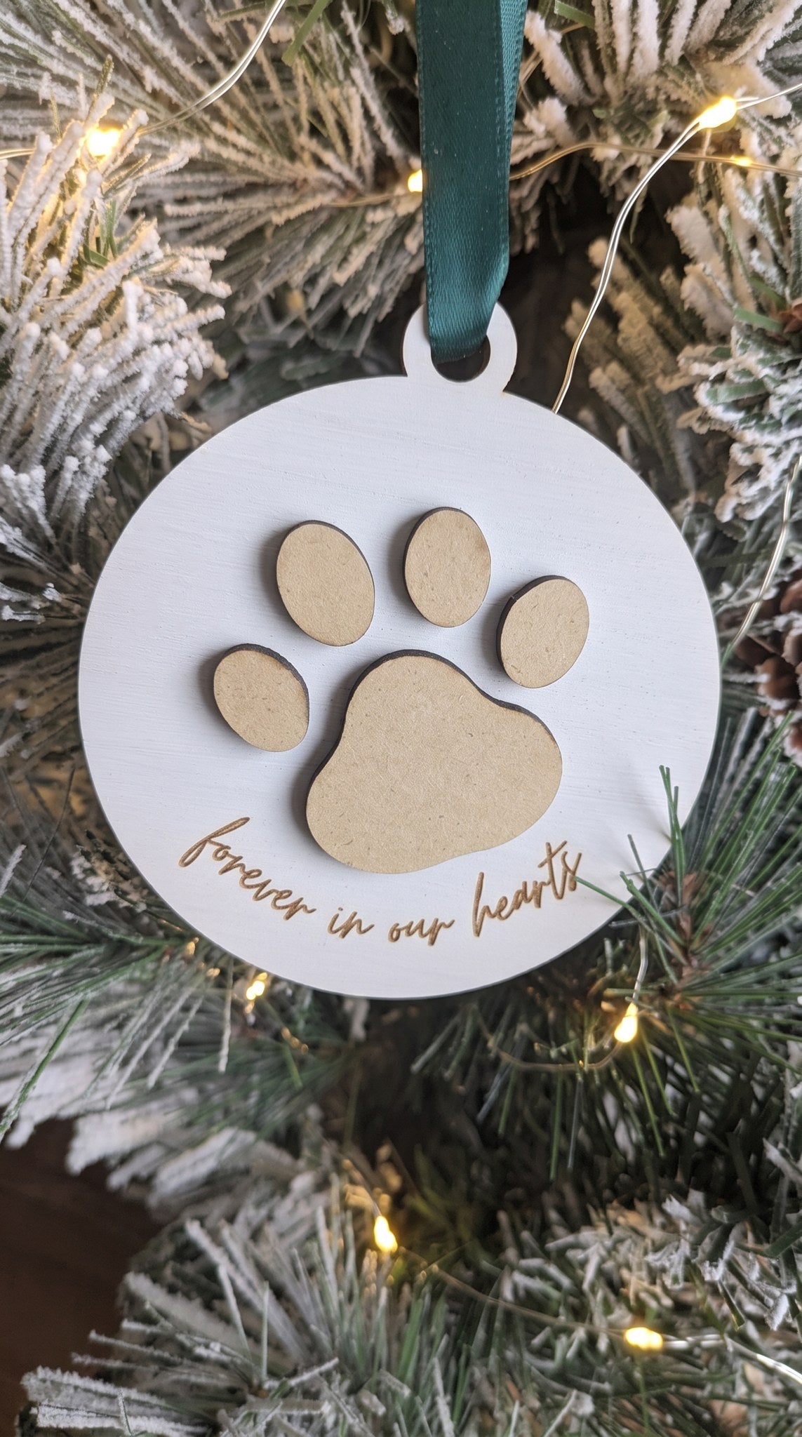 White round pet memorial ornament with wooden paw print, forever in our hearts