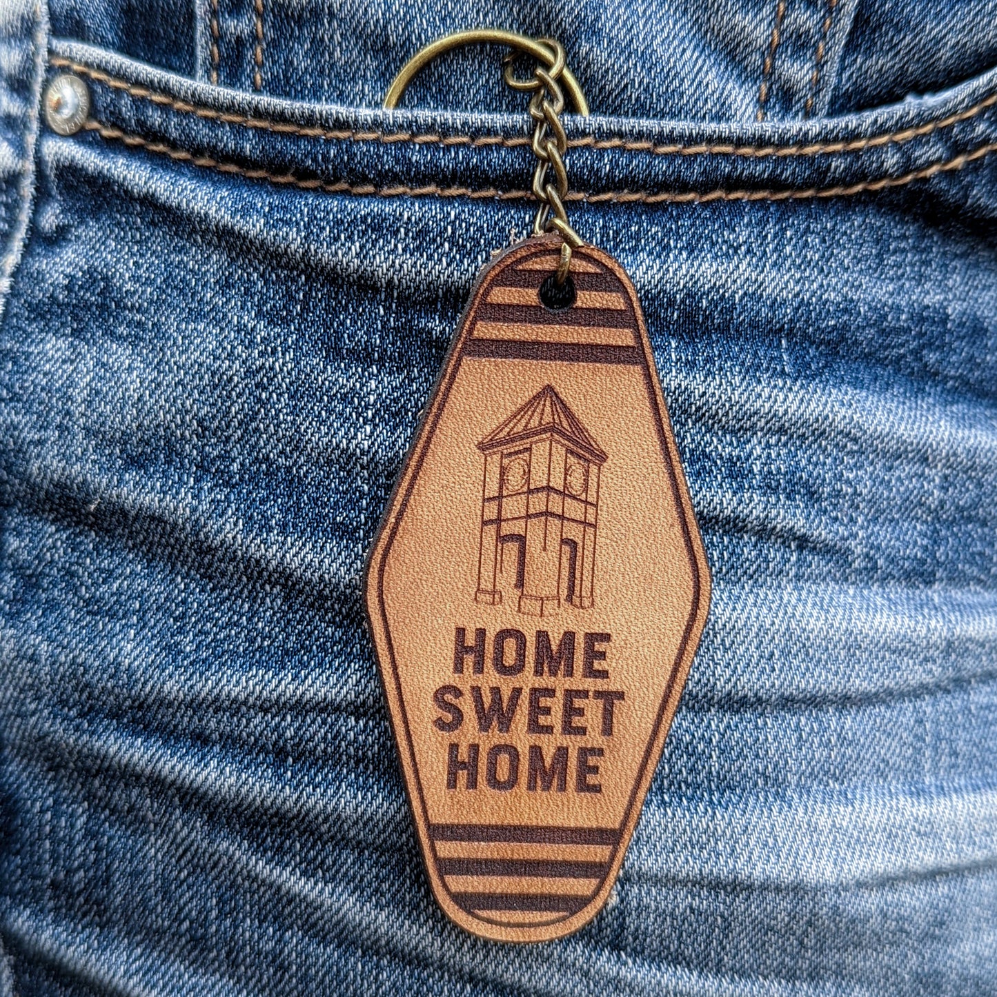 Leather Keychain cut and engraved to look like a vintage motel key with Home Sweet Home and an illustration of the Cornwall Clock Tower engraved on it.