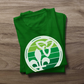Folded Retro-Inspired Franco-Ontarien Shirt on a wooden background, featuring a design with the trillium and fleur-de-lys.