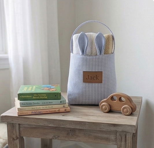 Storage basket with bunny ears, books, and a wooden car on a wooden table.