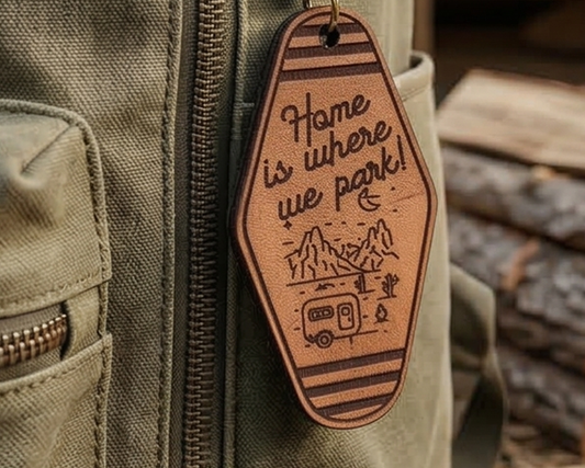 Leather tag with 'Home is where we park' text on a green bag