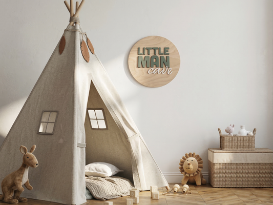 Children's room with a teepee, toys, and a decorative sign on the wall.