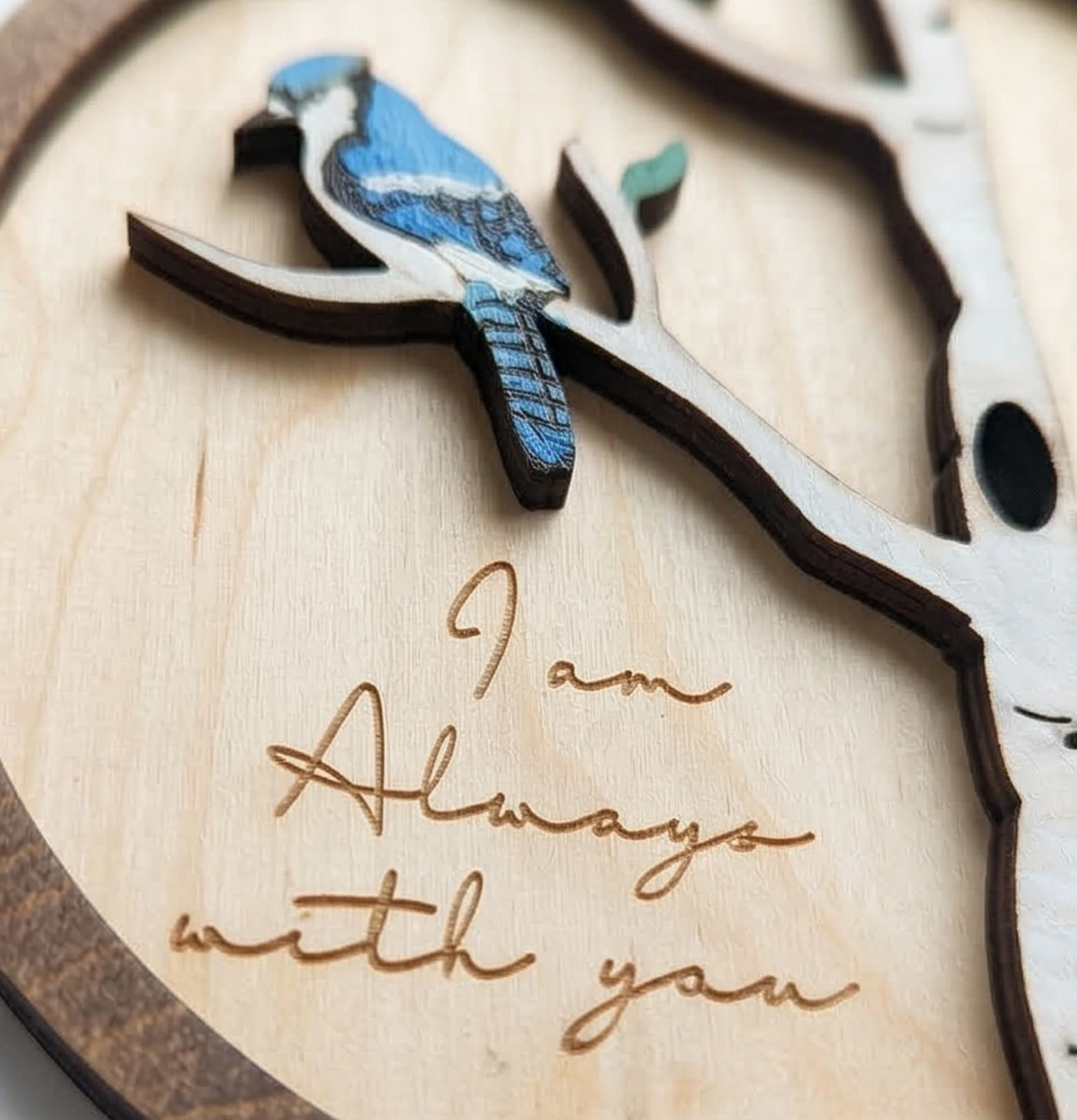 Wooden art with blue jay bird and branch, featuring the engraving 'I am Always with you'.
