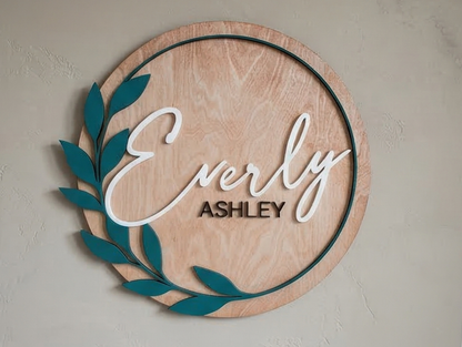 Wooden wall decor with 'Everly Ashley' text on a plain background