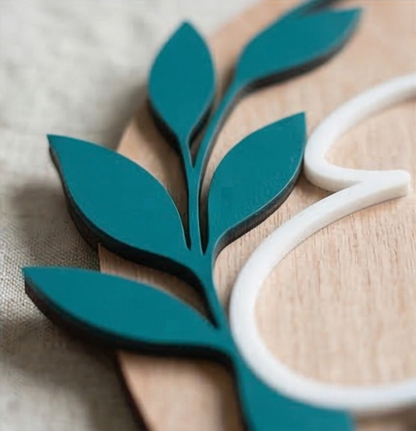 Teal leaf-shaped object on a wooden surface