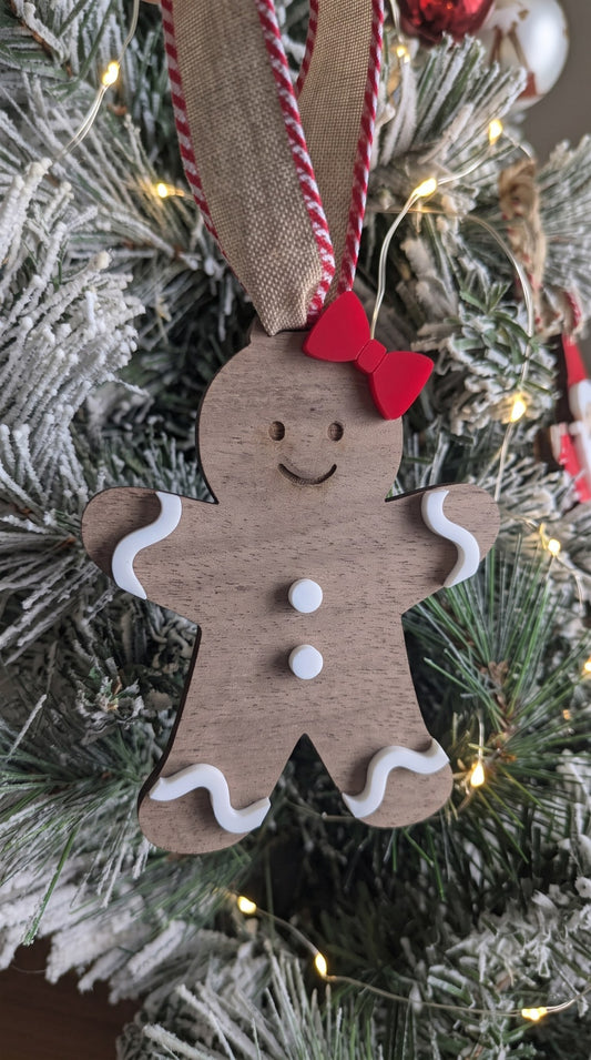 Layered walnut and acrylic gingerbread girl ornament with red bow