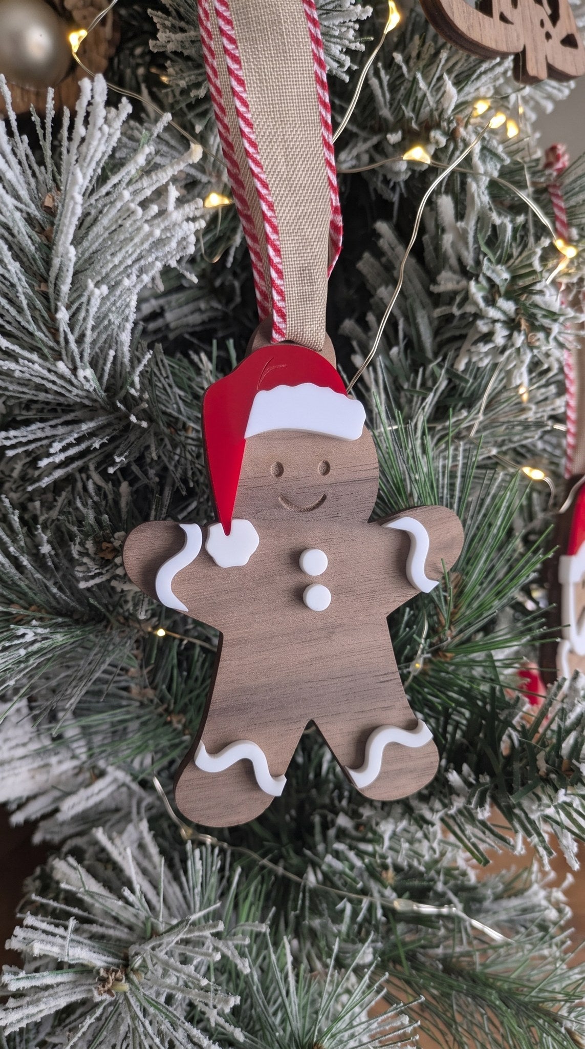 Layered walnut and acrylic gingerbread boy ornament with Santa hat