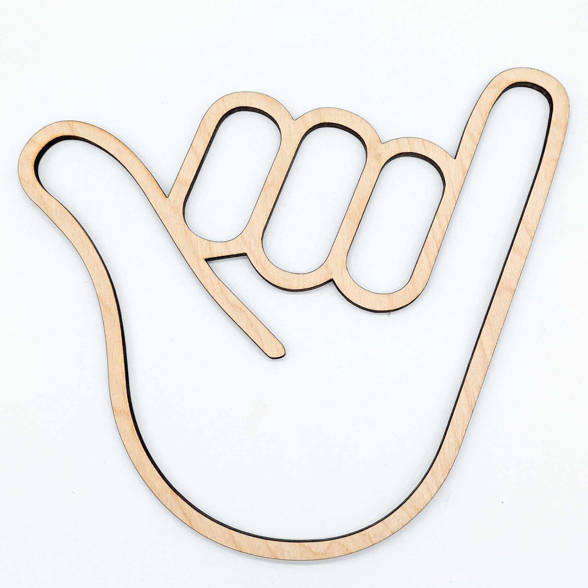 wooden cutout of a hand in the shaka sign position on white background