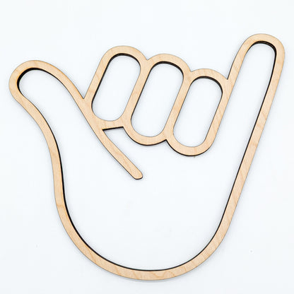 wooden cutout of a hand in the shaka sign position on white background